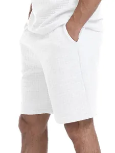 Close-up of white waffle knit texture on men's summer relaxed fit shorts set.