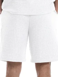Close-up detail of men's white leisure shorts featuring premium waffle texture pattern.