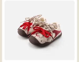 Detail of breathable beige baby walker shoes with vibrant red bows.