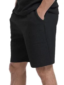 Close-up detail of the premium black waffle knit texture on men's casual athletic shorts