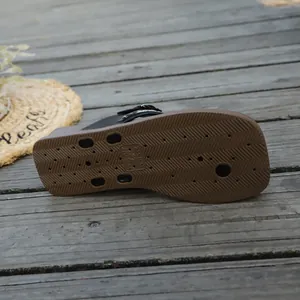 Detail view of the brown anti-slip rubber sole of women's casual flip-flops