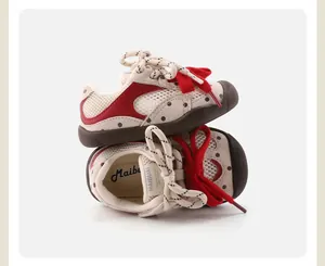 Detail view of breathable baby pre-walker shoes featuring mesh fabric and a red decorative bow