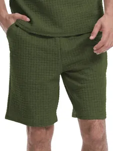 Close-up of olive green waffle texture fabric on men's summer casual shorts set.
