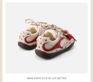 Rear view detail of breathable mesh infant sneakers with red accents and polka dots