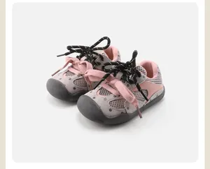 Detail view of pink and grey baby sports shoes with mesh upper and non-slip rubber sole.