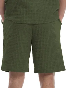 Back view of men's olive green waffle texture shorts in a loose summer casual style.