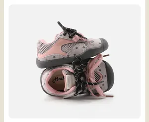 Detail macro view of pink and grey polka dot baby walking shoes with mesh fabric