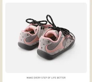 Close-up back view of pink and grey toddler outdoor sneakers with polka dot design