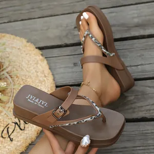 Brown platform thong sandals with snake pattern straps and metallic buckle detail