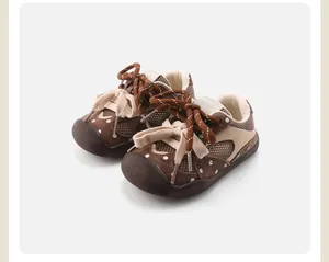 Detail view of brown mesh baby walking shoes with polka dots and double sport laces