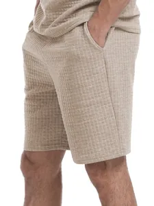 Close-up detail of men's summer waffle-knit short set in beige showing fabric texture