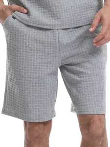 Detailed macro shot of grey waffle grid texture on men's casual sports shorts fabric