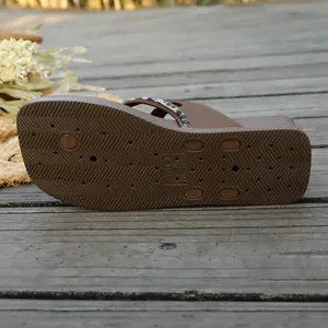 Detailed view of brown flip flop anti-slip outsole featuring wavy grip patterns