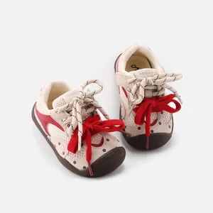 Stylish breathable baby walking sneakers with polka dots and vibrant red ribbon laces