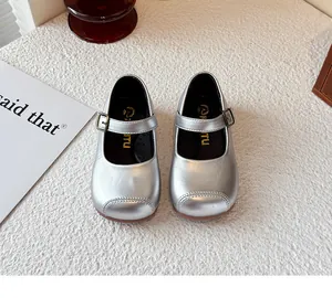 Top-down view of shiny silver Mary Jane shoes for girls with buckle detail