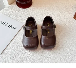 Overhead view of classic brown children's Mary Jane leather shoes with buckle straps.