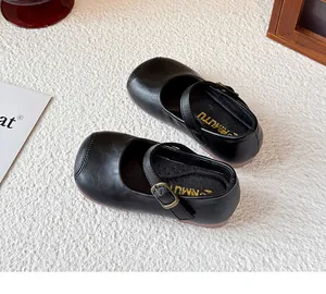 Detailed view of black girls Mary Jane shoes with classic buckle strap and soft sole