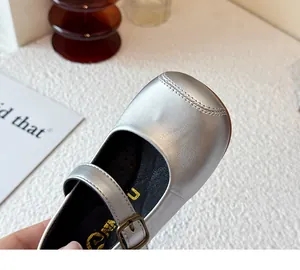 Close-up detail of the smooth silver metallic finish on a girl's soft leather Mary Jane shoe
