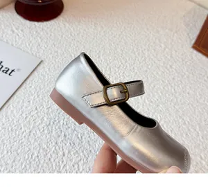 Close-up of girls silver metallic Mary Jane princess shoe with vintage bronze buckle