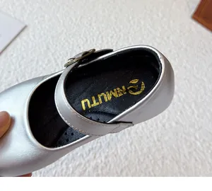 Close-up of silver metallic girls princess shoe with buckle strap and logo