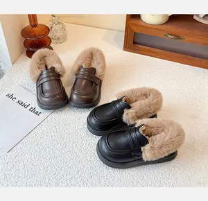 Close-up detail of children's warm fur-lined loafers in black and brown leather colors