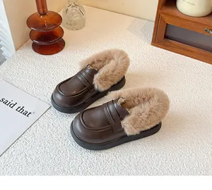 Close-up detail view of cozy brown children's loafers with thick faux fur lining for winter.