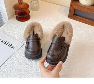 Close-up detail of warm children's winter fur-lined leather loafers with soft soles
