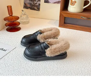 Detail view of children's black leather winter loafers with warm beige faux fur lining