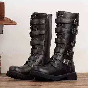 Detailed view of black tall combat boots with decorative skull buckles and straps
