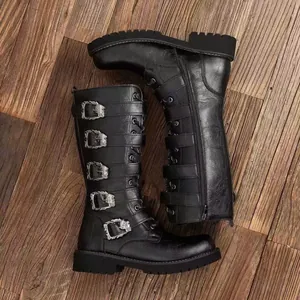 Punk style black leather high-top boots with decorative skull buckles and side zipper.
