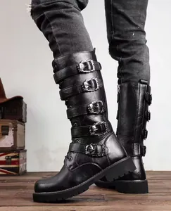 Detail of black high-top punk boots featuring five buckle straps with skull accents