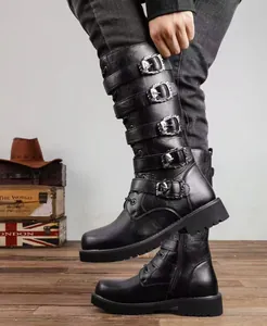 Close-up of black tall biker boots with gothic skull buckles on leather straps