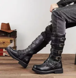 Detailed view of black men's knee-high punk boots with multiple buckle straps