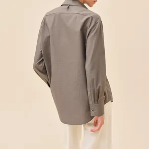 Premium brass buttons displayed on a taupe monogram long-sleeved shirt, back view