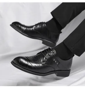 Side view of black business dress shoes with unique hand-clutch texture and pointed toe