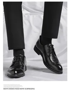 Macro view of black hand-gripped texture leather dress shoes with formal lace-up design