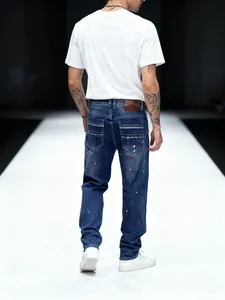 Back view detail of straight-leg denim pants showing a colorful paint splatter pattern design