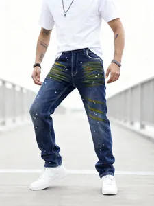 Close-up of men's straight jeans with unique yellow whiskers and white paint splatter details.