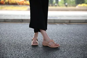 Stylish women's thick sole sandals with metal buckle shown in an outdoor casual setting