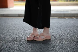 Close-up of pink platform sandals with metal buckles for casual summer comfort