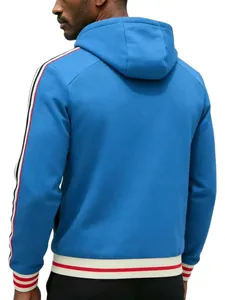 Detailed back view of a bright blue men's zip-up hoodie featuring striped ribbing accents
