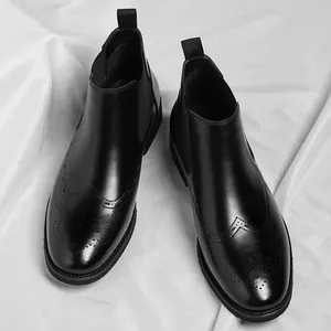 Classic black leather Chelsea boots with elegant brogue wingtip detailing for men