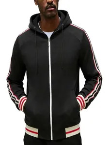 Detailed view of men's black zip-up hoodie with red and white striped sleeve tape