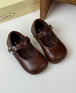 Vintage dark brown leather Mary Janes for girls with buckle strap and round toe detail