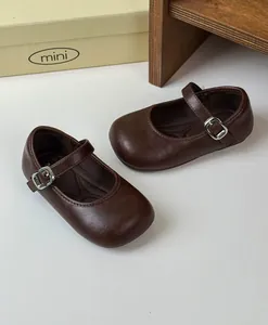 Close-up view of retro dark brown leather Mary Jane shoes for girls with metal buckle