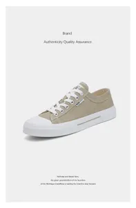 Detailed view of retro khaki canvas low-top sneakers with white rubber soles and laces.