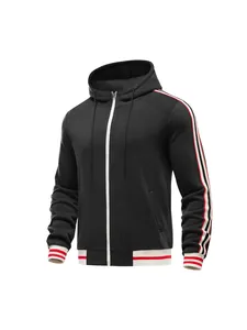 Detailed shot of men's black zip-up hoodie featuring red and white striped sleeve webbing