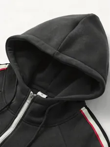 Close-up of men's dark grey zip-up hoodie featuring red and white stripe webbing detail