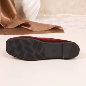 Detail van de antislip rubberen zool van de bordeauxrode fluwelen platte schoenen.