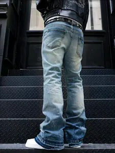 Back view of vintage washed grey paint splatter curved jeans featuring a wide leg fit